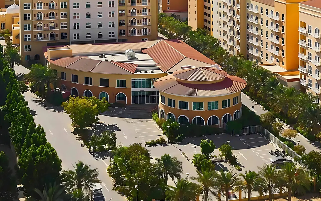 Ritaj residential buildings and community courtyard photograph from Dubai Investments Real Estate. Area context, not a photograph of DAMAC Riverside – Lush.