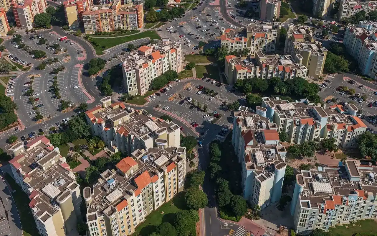 Completed Discovery Gardens apartment clusters, tree-lined streets and landscaped courtyards. Area context, not a photograph of Mog 184.