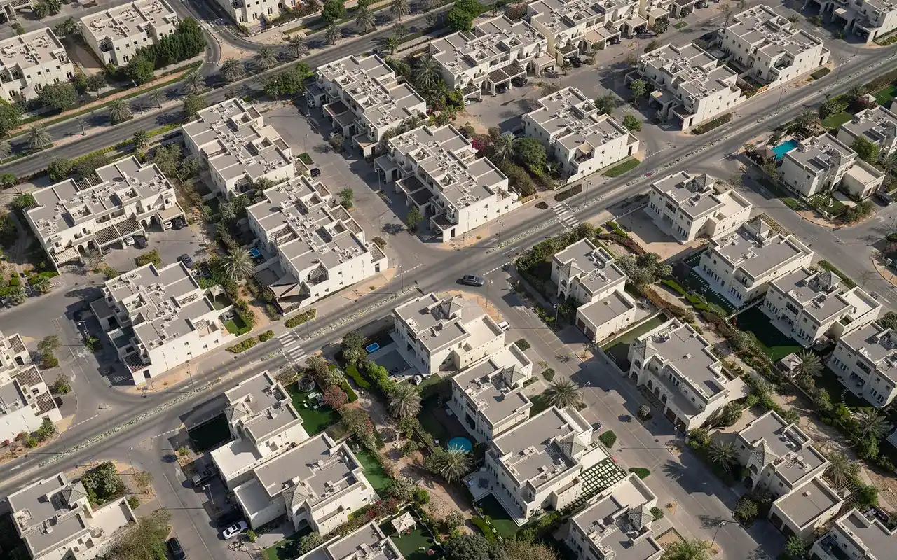 Completed Al Furjan villas and residential streets seen from above. Area context, not a photograph of DMCC Uptown EZ2.