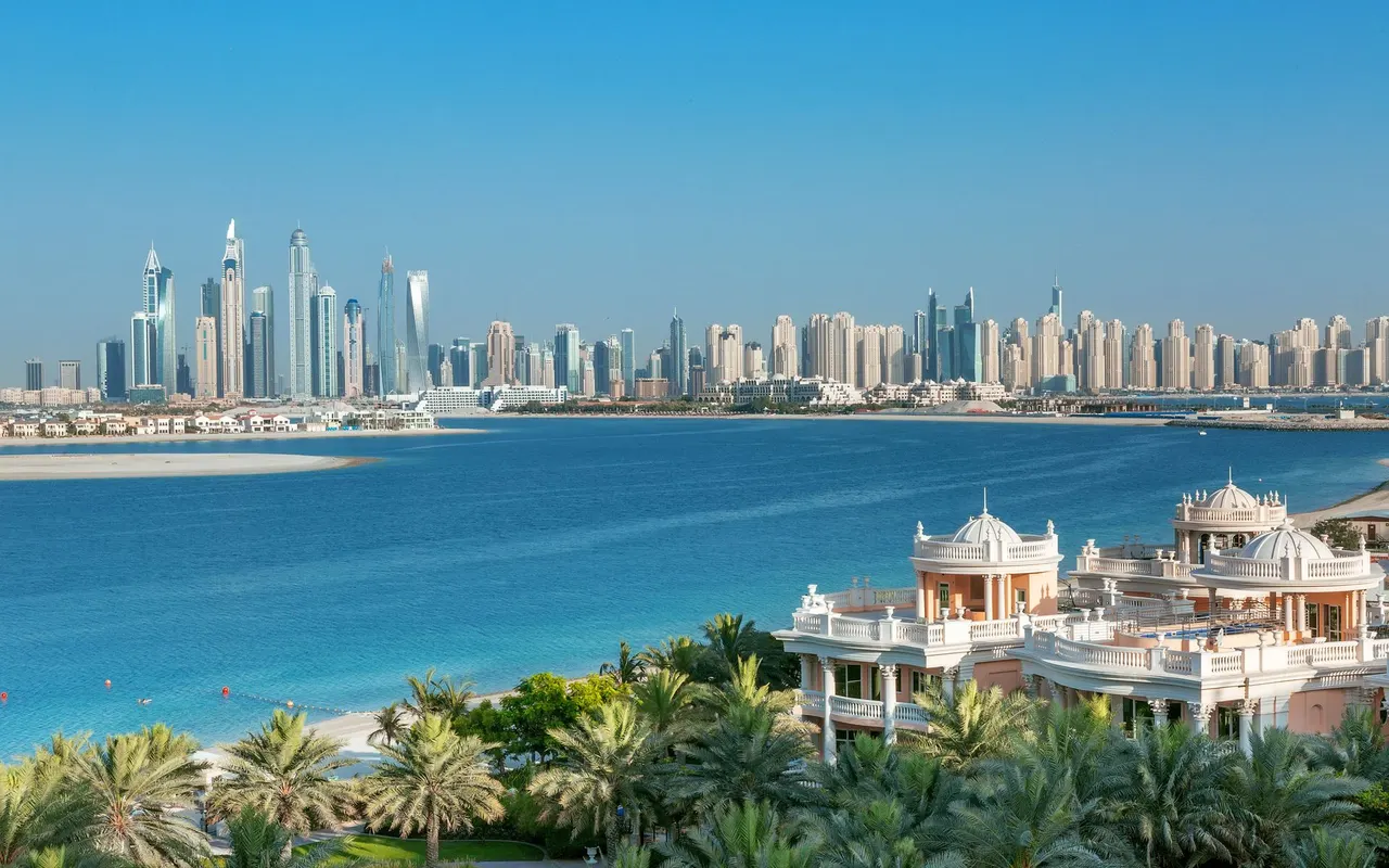 Palm Jumeirah waterfront villas with the Dubai Marina skyline across the water. Area context, not a photograph of Azure Residences.
