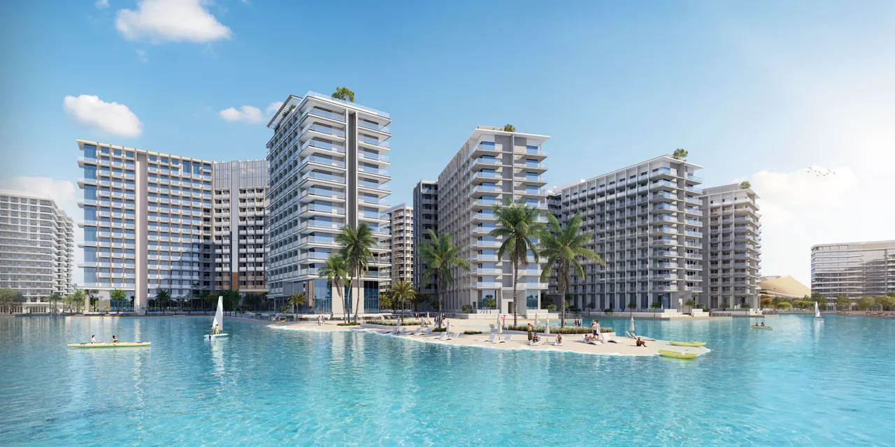 Azizi Venice project-wide developer render of residential blocks beside the lagoon; individual tower numbers are not identified. Azizi Venice project-wide developer render. Individual tower not identified.