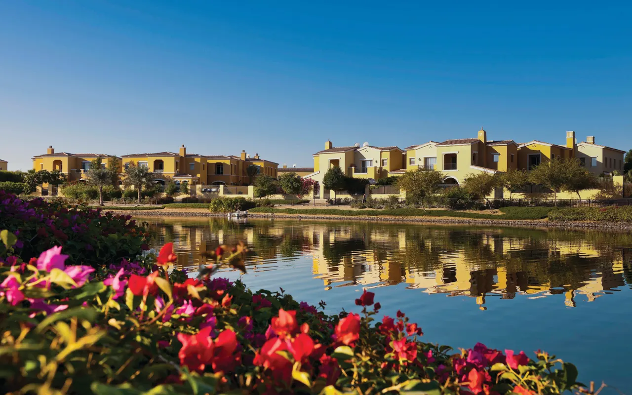 Completed Arabian Ranches villas reflected in a landscaped lake. Area context, not a photograph of Arabian Ranches – Alvorada III.