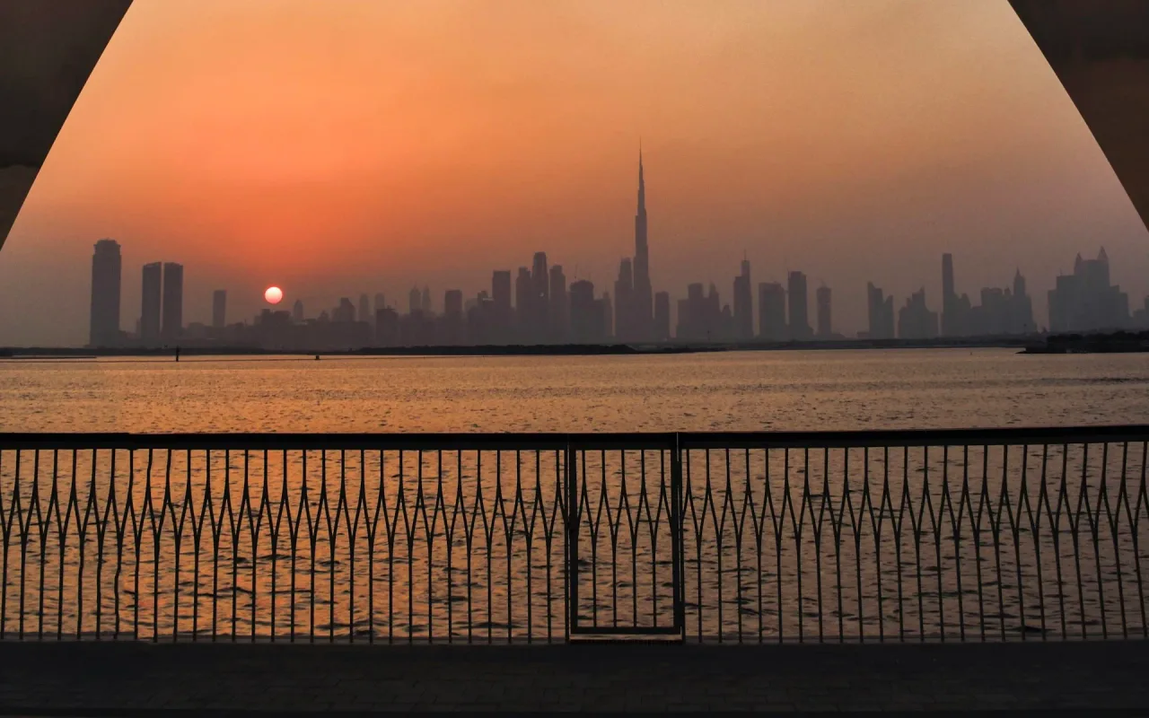 Dubai skyline at sunset viewed across water from Dubai Creek Harbour. General Dubai context, not Al Hebiah Fifth.. Area context, not a photograph of Al Ramth 26.