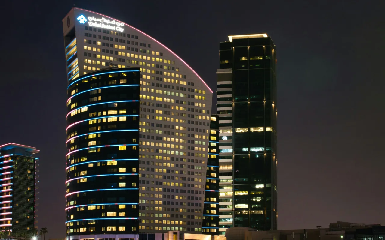 Completed hotel buildings illuminated at night in Dubai Festival City.. Area context, not a photograph of Marsa Plaza – Core 2.