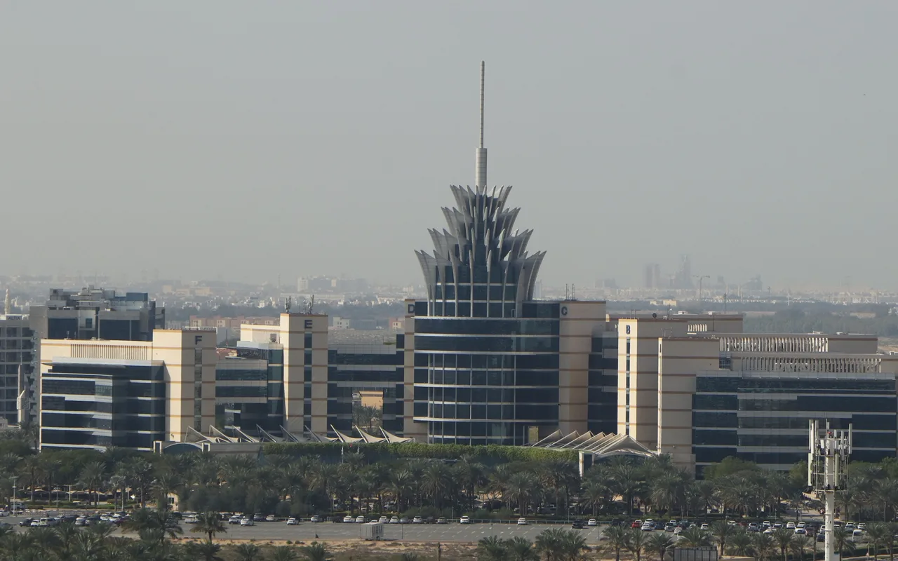 Dubai Silicon Oasis headquarters above palm-lined roads. Dubai Silicon Oasis district context; the specific registry subdivision boundary is not verified.. Area context, not a photograph of University View C.