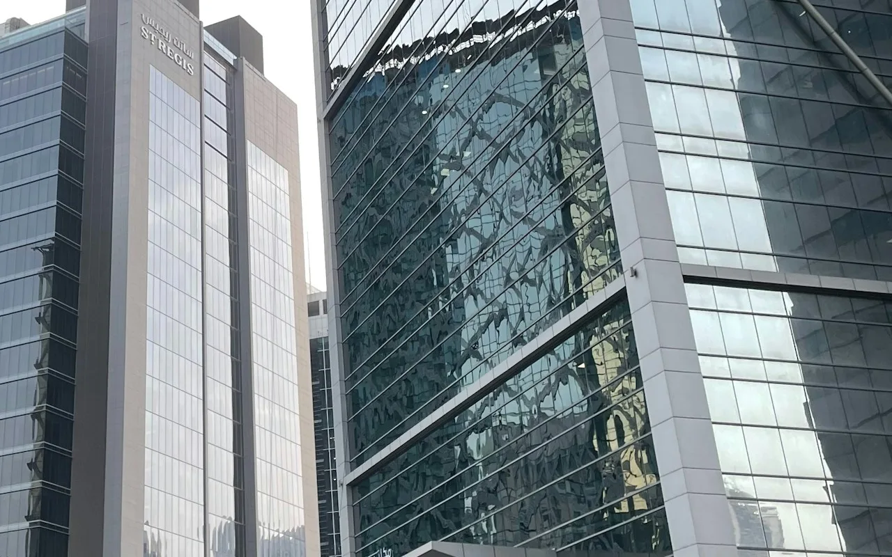 Completed hotel and office façades on Al Ohood Street in Business Bay. Area context, not a photograph of Avanti Tower.